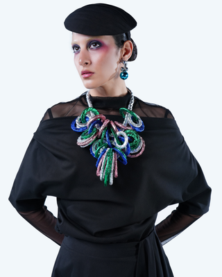 Model wearing Hüna Linen Asymmetrical Blouse – draped neckline and fluid silhouette from the Volume Noir Collection.