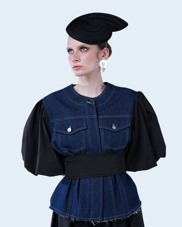 Model wearing Hüna Balloon Sleeve Jacket — denim and taffeta jacket with voluminous sleeves and belted waist from the Volume Noir Collection.