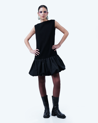 Model wearing Hüna Crepe–Taffeta Dress – structured silhouette with taffeta bubble hem and back ribbon detail from the Volume Noir Collection.