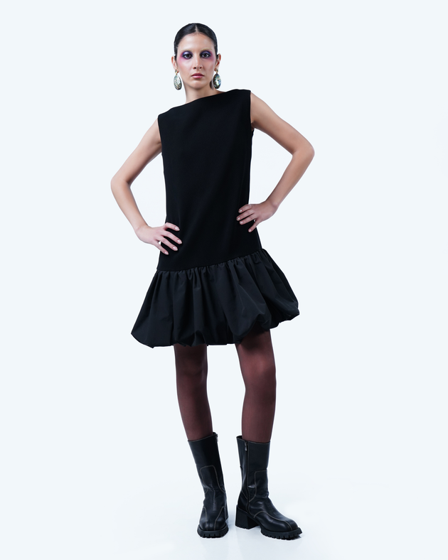 Model wearing Hüna Crepe–Taffeta Dress – structured silhouette with taffeta bubble hem and back ribbon detail from the Volume Noir Collection.