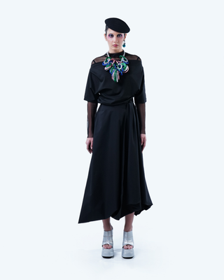 Model wearing Hüna Taffeta Draped Skirt – sculptural asymmetric silhouette from the Volume Noir Collection.