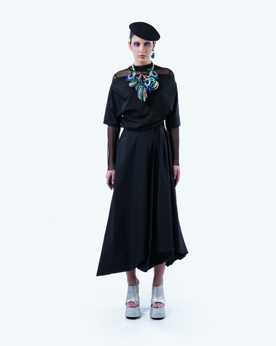 Model wearing Hüna Taffeta Draped Skirt – sculptural asymmetric silhouette from the Volume Noir Collection.