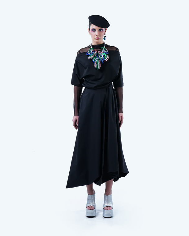 Model wearing Hüna Taffeta Draped Skirt – sculptural asymmetric silhouette from the Volume Noir Collection.