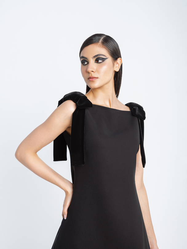 Close-up of Hüna Fara Dress — premium crepe fabric with velvet shoulder bow detail and acetate lining