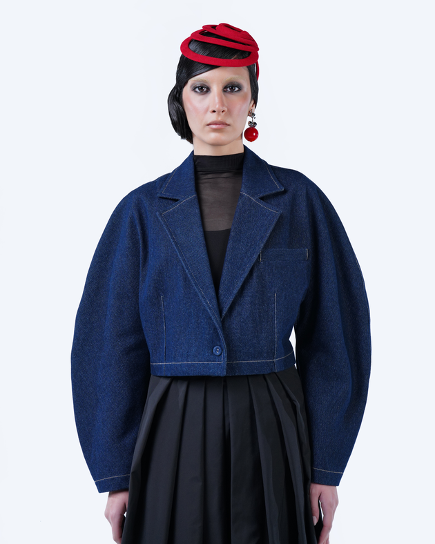 Model wearing Hüna Denim Crop Jacket — structured cropped denim blazer with voluminous sleeves from the Volume Noir Collection