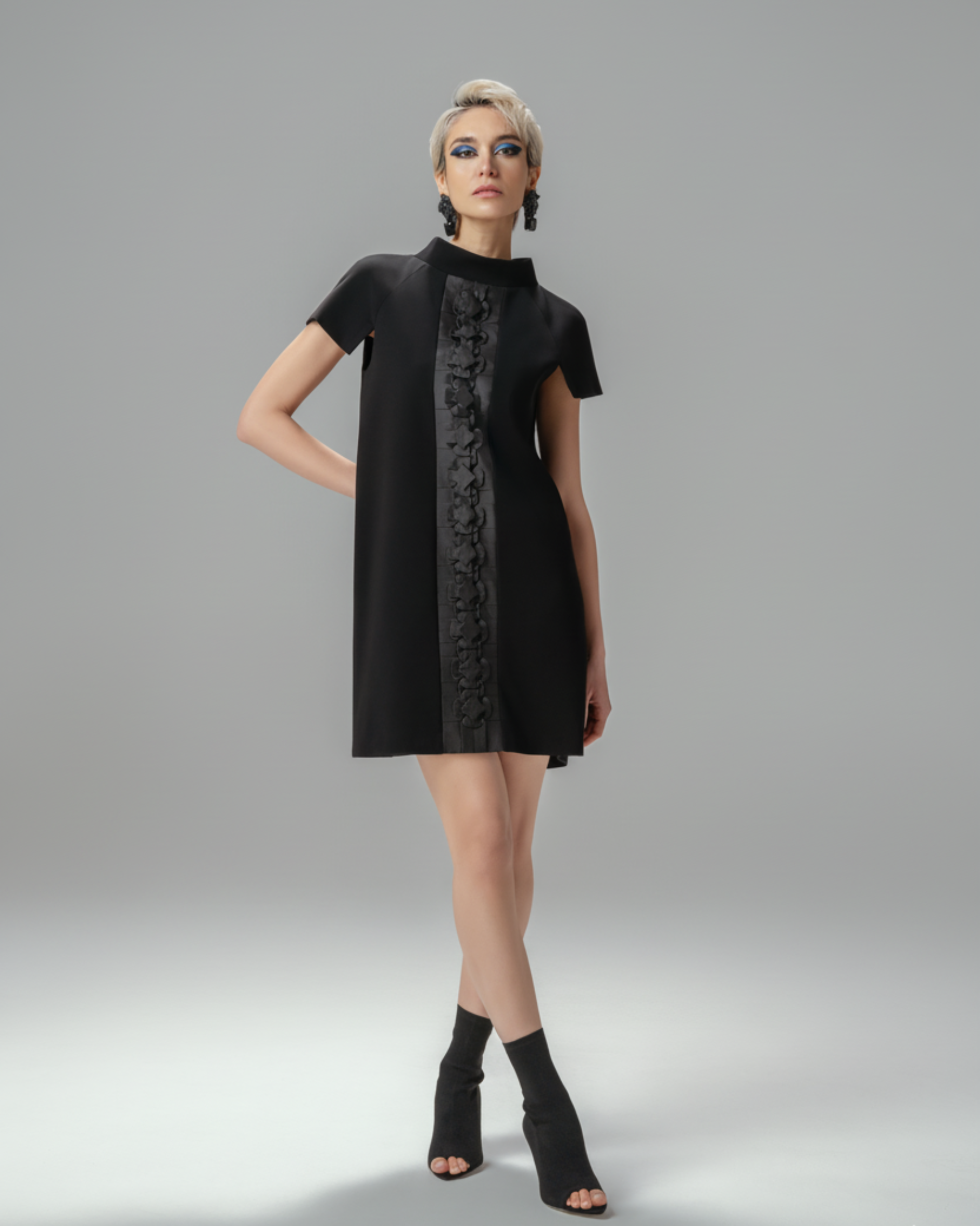 Model wearing Hüna Sakura Dress — black crepe dress with handmade origami detailing, limited edition design