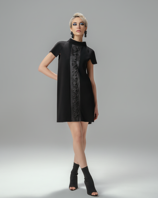 Model wearing Hüna Sakura Dress — black crepe dress with handmade origami detailing, limited edition design