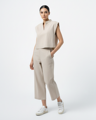 Model wearing Hüna Diba Suit — sleeveless linen-blend top with matching wide-leg trousers, limited edition minimalist design