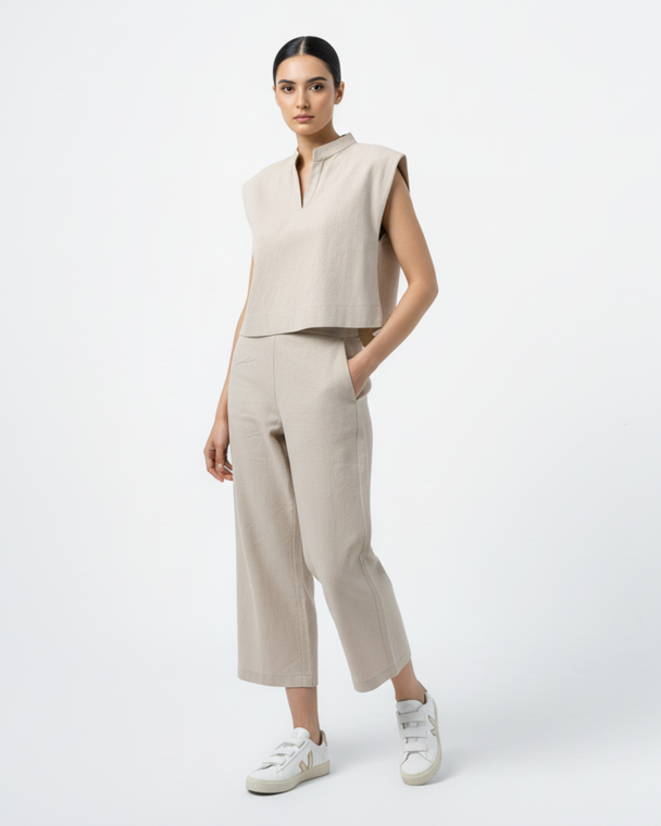Model wearing Hüna Diba Suit — sleeveless linen-blend top with matching wide-leg trousers, limited edition minimalist design