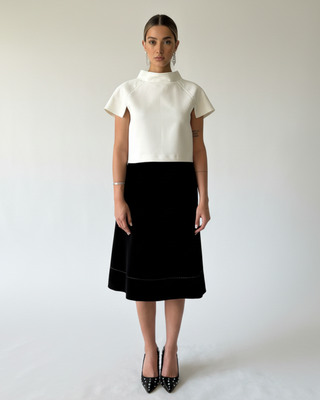 Model wearing Hüna Niloofar Top — white crepe top with high collar, decorative stitches, and back button closure