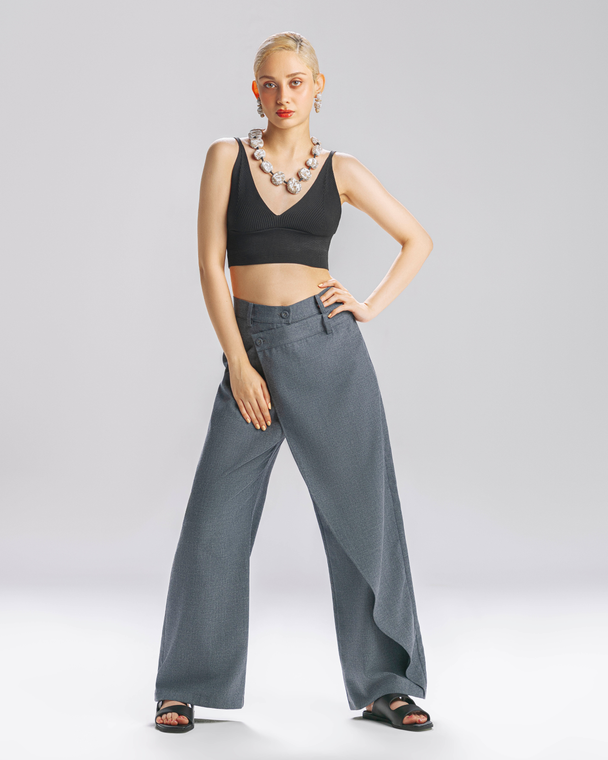 Model wearing Hüna Azar Pants — wide-leg wool-blend trousers with sculptural draped panel, limited edition design